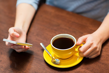 Image showing close up of woman with smartphone and coffee