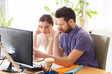 Image showing creative team with reading paper in office