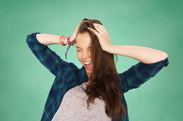 Image showing happy student teenage girl holding to head