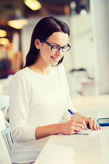 Image showing smiling woman with tablet pc at cafe