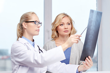 Image showing woman patient and doctor with spine x-ray scan