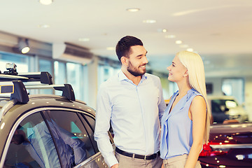 Image showing happy couple buying car in auto show or salon