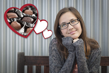 Image showing Daydreaming Girl Next To Floating Hearts with Chocolates