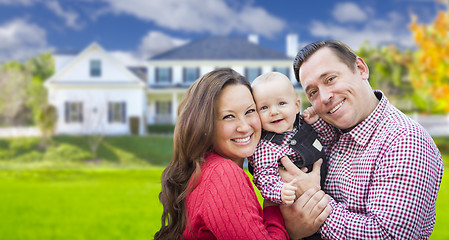 Image showing Young Family With Baby Outdoors In Front of Custom Home