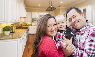 Image showing Young Family Inside Beautiful Custom Kitchen