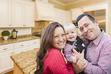 Image showing Young Family Inside Beautiful Custom Kitchen