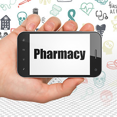 Image showing Medicine concept: Hand Holding Smartphone with Pharmacy on display