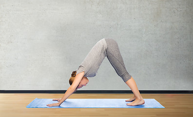 Image showing woman making yoga dog pose on mat