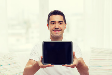 Image showing smiling man showing tablet pc blank screen at home