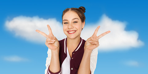 Image showing happy smiling teenage girl showing peace sign