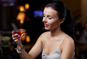 Image showing glamorous woman with cocktail at night club or bar