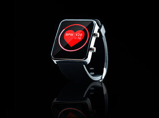 Image showing close up of black smart watch with heart beat icon