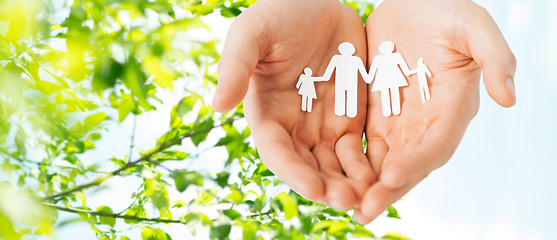 Image showing man hands holding paper cutout of family