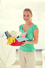 Image showing happy woman holding cleaning stuff at home