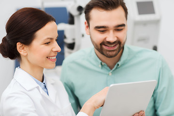 Image showing optician with tablet pc and patient at eye clinic