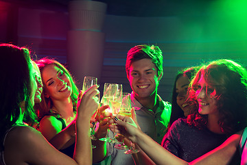 Image showing smiling friends with glasses of champagne in club