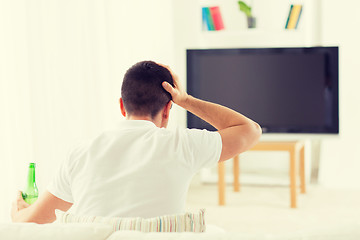 Image showing man watching tv and drinking beer at home