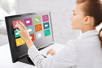 Image showing businesswoman with computer touchscreen in office