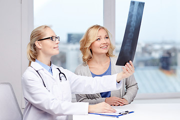 Image showing woman patient and doctor with spine x-ray scan