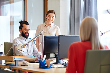 Image showing happy creative team with computers in office