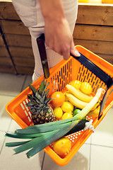 Image showing close up of woman with food basket in market