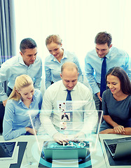 Image showing smiling business people with laptop in office