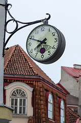 Image showing The town clock on the background of tiled roofs of Tallinn, clos