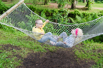 Image showing Children swinging in a hammock