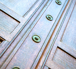 Image showing in london antique brown door  rusty  brass nail and light