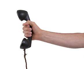 Image showing Male hand holding retro landline telephone