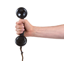 Image showing Male hand holding retro landline telephone