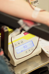 Image showing Donor in an armchair donates blood,, close-up