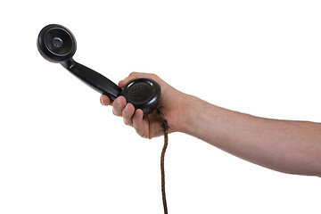 Image showing Male hand holding retro landline telephone