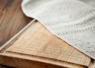 Image showing wooden cutting board and linen napkin