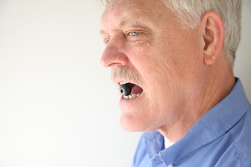 Image showing Man with blueberry in mouth