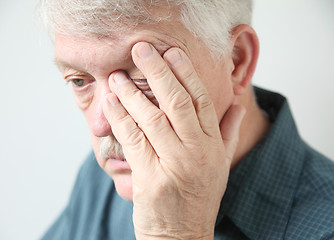 Image showing Tired man rubbing his eye