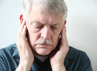 Image showing Senior with pain in front of ears	