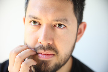 Image showing Young man scratching his beard