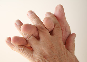 Image showing Man twines fingers together.