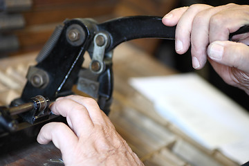 Image showing Letterpress printer cutting metal slugs