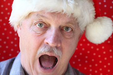 Image showing Santa hat on man looking alarmed