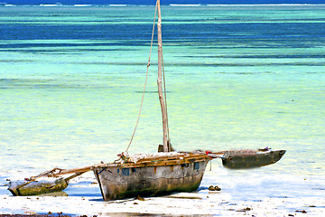 Image showing zanzibar beach  seaweed in indian      sand isle  sky and boat