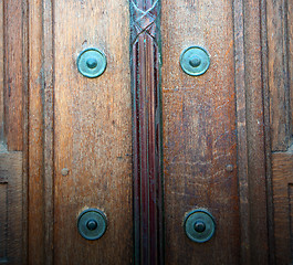 Image showing in london antique brown door  rusty  brass nail and light