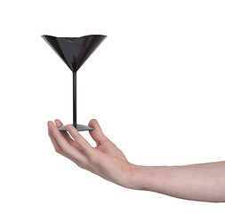 Image showing Black plastic coctail glass in hand