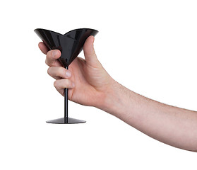 Image showing Black plastic coctail glass in hand