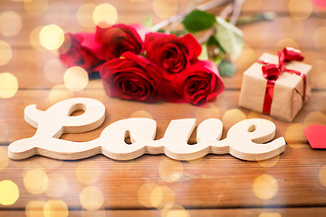 Image showing close up of gift, word love, red roses and hearts