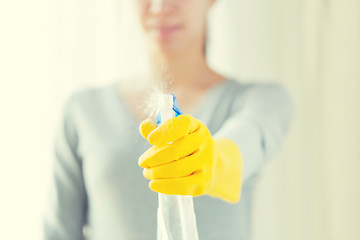 Image showing close up of happy woman with cleanser spraying