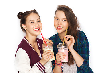 Image showing happy pretty teenage girls drinking milk shakes