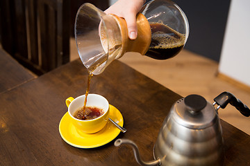 Image showing close up of barista woman with coffeemaker and cup