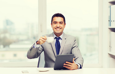 Image showing smiling businessman with tablet pc and coffee cup